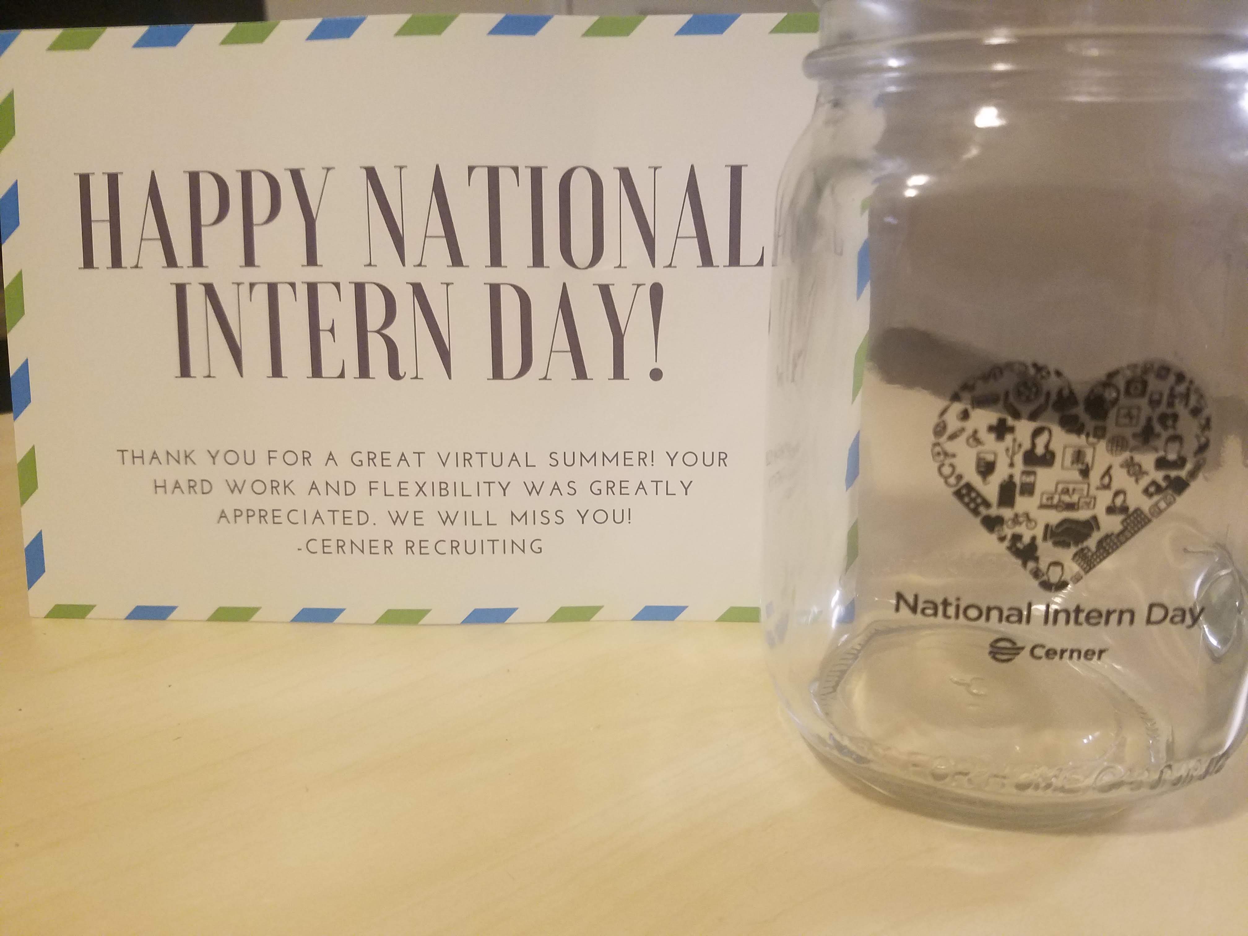 A note card that says Happy National Intern Day with a glass cup next to it with the Cerner logo on it and a heart shape filled with healthcare symbols