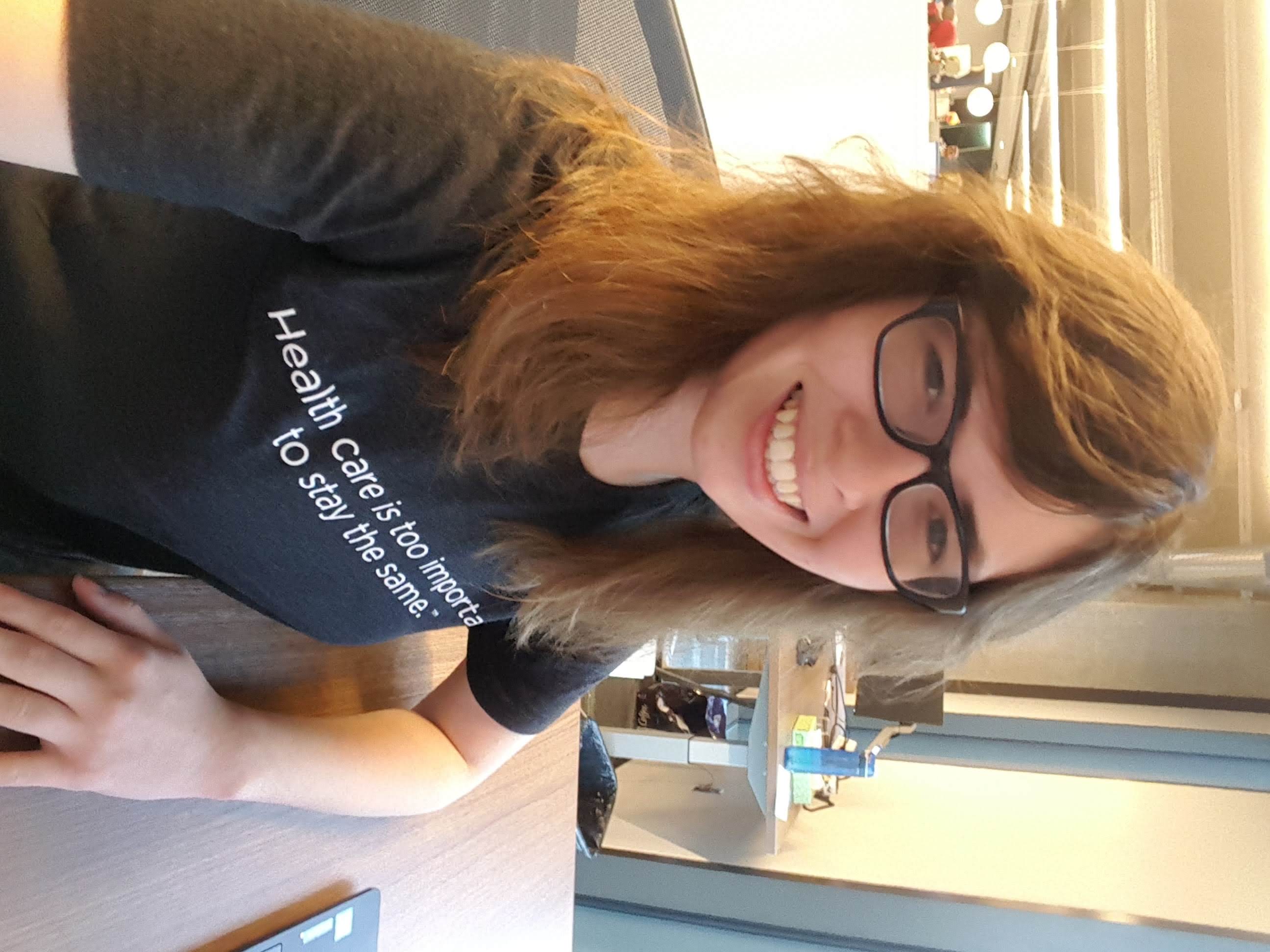 Lauren smiling at a desk