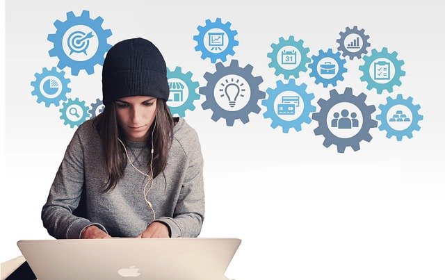 A woman typing on a Mac laptop with icons in the air behind her representing project related tasks